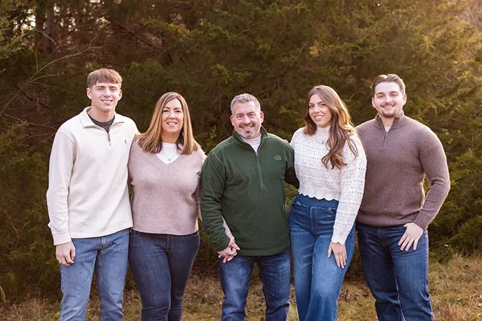 A family portrait of Dr. Corey Piva, his wife, sons, and daughter